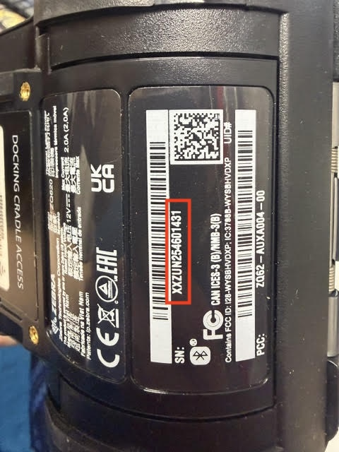 Printer label under the battery door with the serial number after SN outlined in red